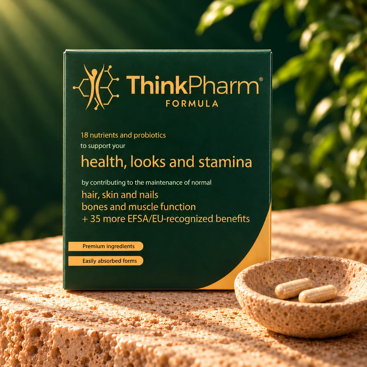 ThinkPharm Formula pack on warm stone beside a bowl with two capsules.